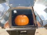 Whole pumpkin baking in a solar oven